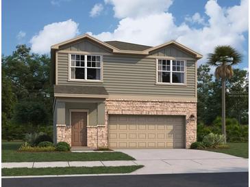 Two-story house with a two-car garage, stone accents and landscaping at 1433 Dalkeith Cv, Sanford, FL 32771