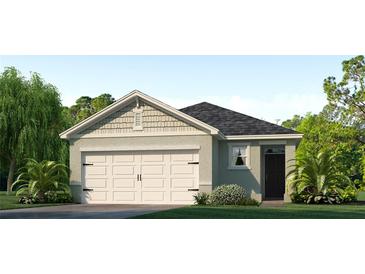 One-story home with light-grey siding, white garage door, and landscaping at 1859 Waggoner St, Kissimmee, FL 34744