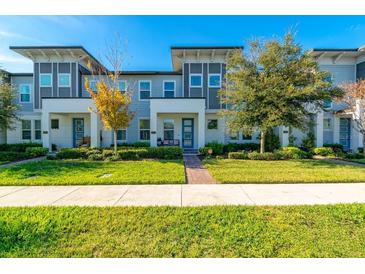 Modern townhouses with landscaped yards and brick walkways at 5814 Bimini Twist Loop, Orlando, FL 32819