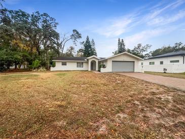 White house with gray garage door and a large grassy yard at 224 Alpine St, Altamonte Springs, FL 32701