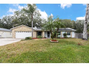 Single-story house with stone facade, attached garage, and well-maintained lawn at 2507 Maui Cir, Kissimmee, FL 34741