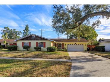 Charming ranch home with mature landscaping and a large tree in the front yard at 3817 Bainbridge Ave, Orlando, FL 32839
