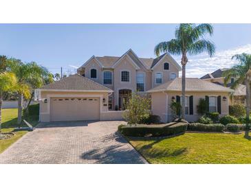 Charming two-story home with a three car garage and a beautifully paved driveway at 14039 Hampshire Bay Cir, Winter Garden, FL 34787