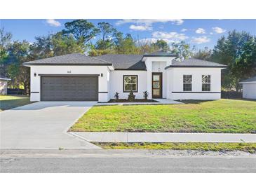 New construction home with a modern design and two-car garage at 162 Nw 42Nd Pl, Ocala, FL 34475
