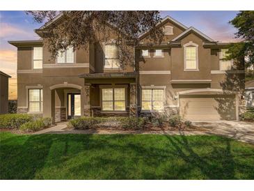 Beautiful two-story home featuring a well-manicured lawn, stone accents, and an attached two-car garage at 264 Wallrock Ct, Ocoee, FL 34761