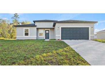 Charming one-story home with a well-manicured lawn and a two-car garage at 265 Marion Oaks Mnr, Ocala, FL 34473