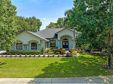 Beautiful home with a well-manicured lawn and a large driveway at 4938 Raylene Way, St Cloud, FL 34771