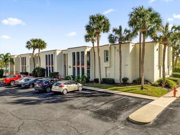 Condo building exterior with parking and palm trees at 526 Orange Dr # 37, Altamonte Springs, FL 32701