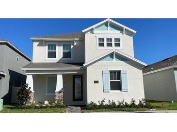 Charming two-story home with white facade, light blue accents, and a well-maintained front yard at 5374 Lake Virginia St, Winter Garden, FL 34787