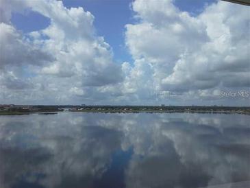 Stunning water view with clouds reflecting on the lake at 8755 The Esplanade # 103, Orlando, FL 32836