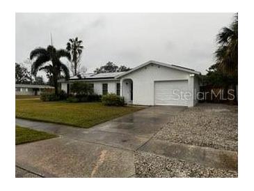 Single-story home with a large yard and attached garage at 102 Aberdeen Dr, Fern Park, FL 32730