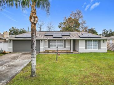 Updated single-story home with solar panels and landscaped lawn at 1113 Matterhorn Street, Deltona, FL 32725