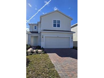 Two-story house with attached garage and brick paver driveway at 1200 Happy Forest Loop, Deland, FL 32720