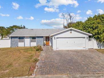 Charming single-story home with a white garage door and landscaped lawn at 7852 Murcott Cir, Orlando, FL 32835