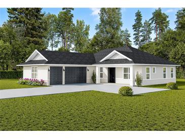 Newly constructed home with a two-car garage and manicured lawn at Tbd Sw 93 St, Dunnellon, FL 34432