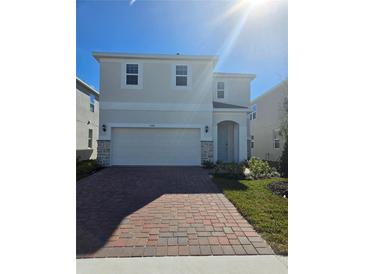 Two-story house with a two-car garage and a brick driveway at 1166 Happy Forest Loop, Deland, FL 32720