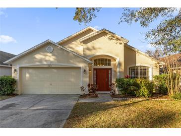 Beautiful one-story home with a two-car garage and well-manicured lawn at 13013 Quail Ct, Orlando, FL 32828