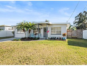 Charming single story home with a well-manicured lawn and tropical landscaping at 4304 Mizell St, Orlando, FL 32812