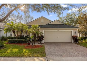 One-story house with a two-car garage and landscaped front yard at 452 Misty Oaks Run, Casselberry, FL 32707