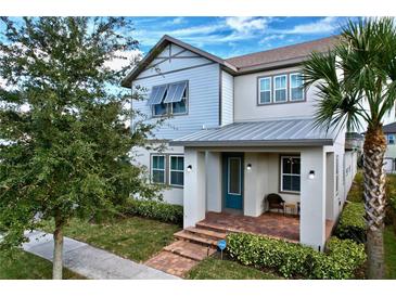 Two-story house with gray siding, metal roof, and a welcoming front porch at 9062 Sperry St, Orlando, FL 32827