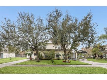 House exterior with large trees, driveway, and carport at 1209 W 6Th St, Sanford, FL 32771