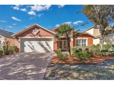 Single-story home with two-car garage and well-manicured landscaping at 140 Gladesdown Ct, Deland, FL 32724