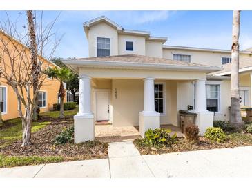 Two-story townhome with front porch and landscaping at 1407 Retreat Cir, Clermont, FL 34714