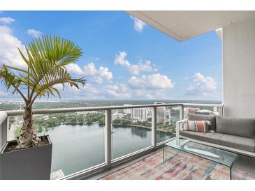 Spacious balcony with city and lake views, seating area, and modern decor at 150 E Robinson St # 3107, Orlando, FL 32801