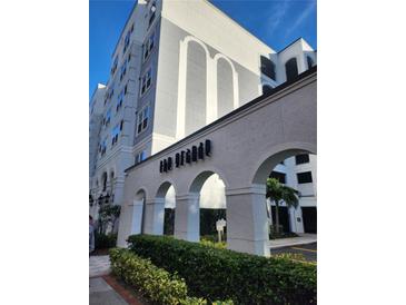 Exterior view of The Grande, a modern building with arched entryways and landscaping at 202 E South St # 1050, Orlando, FL 32801