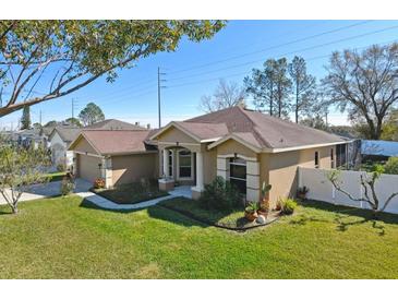 Single-story house with a landscaped lawn and two-car garage at 345 Via Bianca Dr, Davenport, FL 33896