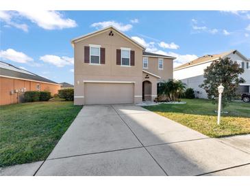 Two-story house with brown front door and attached garage at 6030 Forest Ridge Ln, Winter Haven, FL 33881