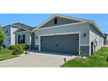 Attractive single-story home with gray siding and a two-car garage at 764 Sarner Pass Way, Winter Haven, FL 33881