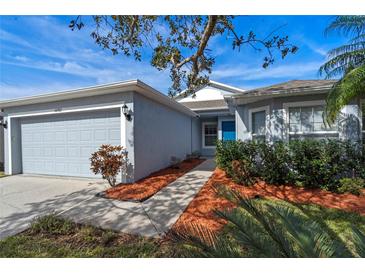 Single-story house with attached garage, landscaping, and walkway at 14783 Yorkshire Run Dr, Orlando, FL 32828