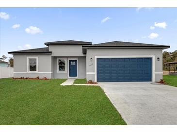New construction home with gray exterior, blue garage door, and landscaped lawn at 15568 Sw 46Th Cir, Ocala, FL 34473
