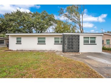 Newly renovated home with a modern facade and well-maintained lawn at 2913 W Amelia St, Orlando, FL 32805