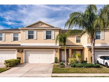 Two-story townhome with attached garage and landscaped front yard at 3018 Bargate St, Orlando, FL 32824