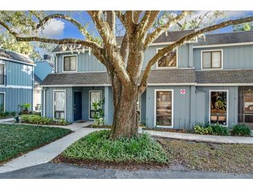 Charming light blue townhome with a large oak tree in the front at 421 Sheoah Blvd # 5, Winter Springs, FL 32708
