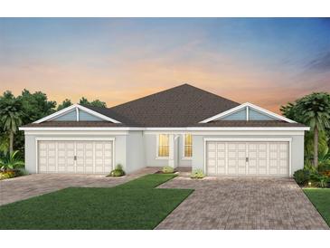 Two-story home with a two-car garage and attractive landscaping at 5180 Gardenrow Dr, St Cloud, FL 34772