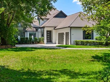 Beautiful two-story home featuring a well-manicured lawn, neutral paint, a black front door, and an attached two-car garage at 9697 Bryanston Dr, Orlando, FL 32827