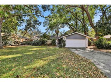 Ranch style home with attached garage and spacious lawn at 2564 Sheffield Ave, Orlando, FL 32806