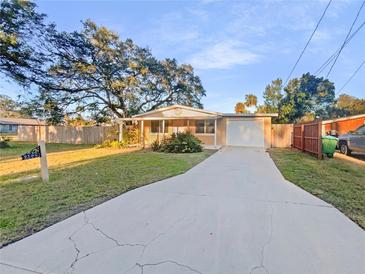 Ranch-style home with a large yard and driveway at 2569 Belmont Ave, New Smyrna Beach, FL 32168