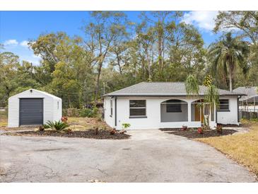 Newly renovated home with a storage shed and landscaped yard at 25753 Vero St, Sorrento, FL 32776