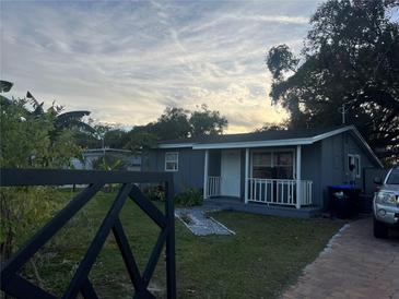 Gray house with white trim, front porch, and landscaped yard at 28 S Hastings St, Orlando, FL 32835