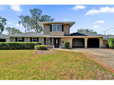 Charming two-story home with a well-manicured lawn and attached two car garage at 3334 N Westmoreland Dr, Orlando, FL 32804