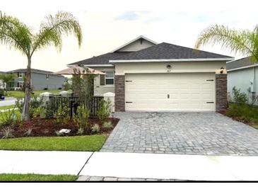 Attractive single-story home with a paved driveway and landscaping at 367 Caryota Ct, New Smyrna Beach, FL 32168