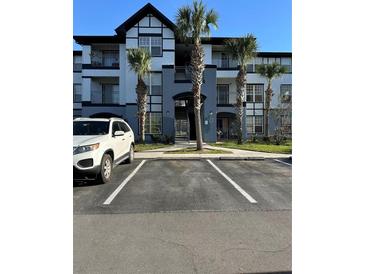 Two-story apartment building with palm trees and parking at 3724 Castle Pines Ln # 4237, Orlando, FL 32839