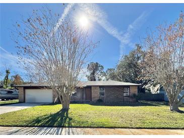 Ranch-style home with a large yard and attached garage at 560 Garden Heights Dr, Winter Garden, FL 34787