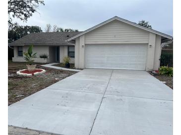 Single-story house with attached garage and landscaped front yard at 9142 Sabal Palm Cir, Windermere, FL 34786