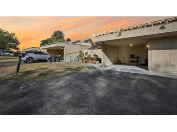 Exterior view of condo with carport and landscaping at 109 Madrid Dr # 109, Casselberry, FL 32707