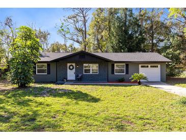 Charming single-story home with beautifully landscaped front yard and freshly painted exterior at 1312 Surf Ave, Apopka, FL 32703